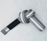 Durable gray-white pearl weave BJJ belt for kids featuring a black rank sleeve and premium cotton stitching.