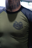 Close-up of the olive green and black BJJLIFESTYLE Bone Breaking Jiu-Jitsu rashguard with snake logo.